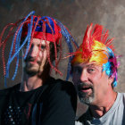 Colorful Hats Worn by Two Men Laughing