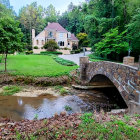 Enchanting forest path with cobblestone bridge and whimsical tree-shaped houses