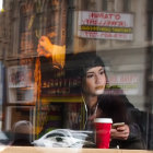 Person in white clown mask at table with red cup, cathedral-like backdrop, and smoky effects