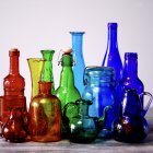 Colorful Glass Bottles, Beads on Wood: Gray Background