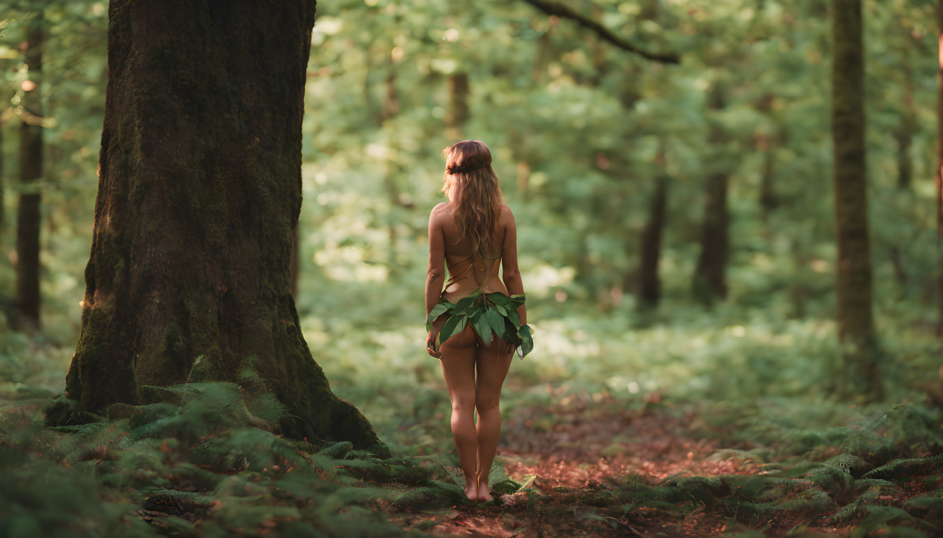 Woman in forest holding leaves surrounded by lush greenery.