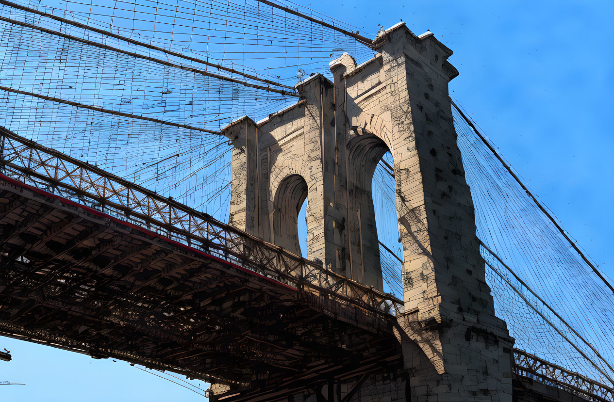 Stone tower of suspension bridge against blue sky with intricate cable patterns.