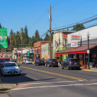 1950s American main street illustration with vintage cars and charming storefronts