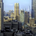 City skyline with skyscrapers under blue sky and sunlight shadows