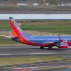 Boeing 737 on Runway with Wetlands Background