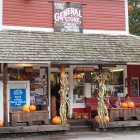 Red-painted General Store with vintage decor and mannequins