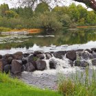 Serene landscape watercolor painting with stone bridge and lush autumnal vegetation