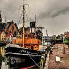 Colorful Tugboat "Tugbilla" at Quaint Harbor with Lighthouse in Rain