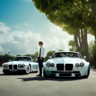 Sophisticated man in suit between luxury cars under clear sky