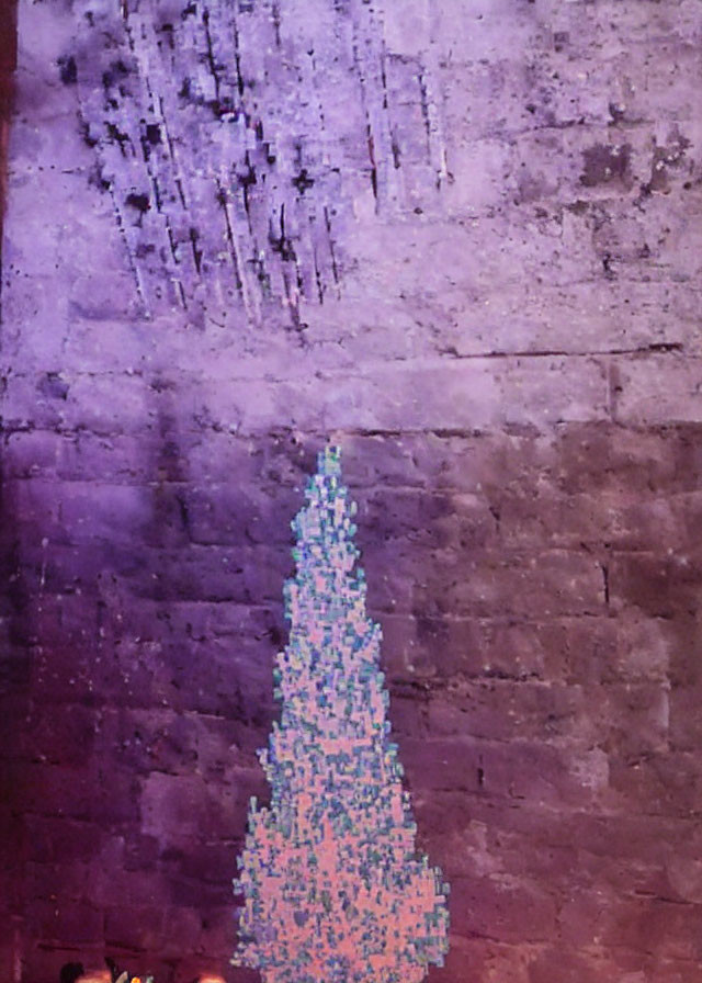 Colorful lone pine tree projection on textured wall: serene ambiance