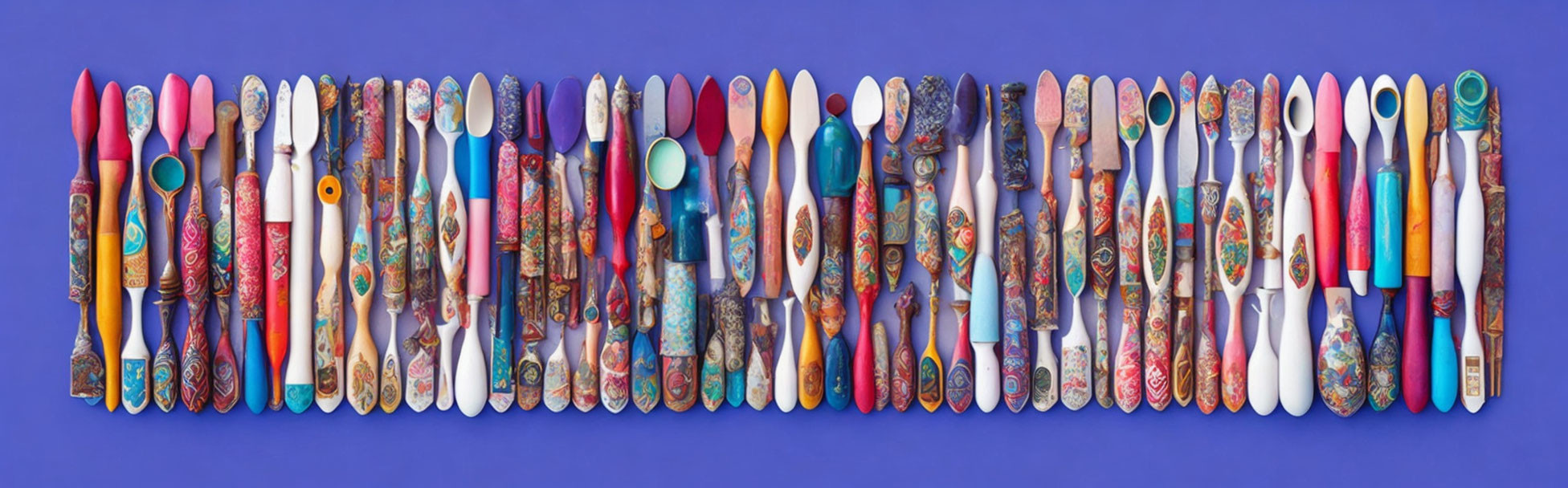 Colorful Cutlery Handles Displayed on Purple Background