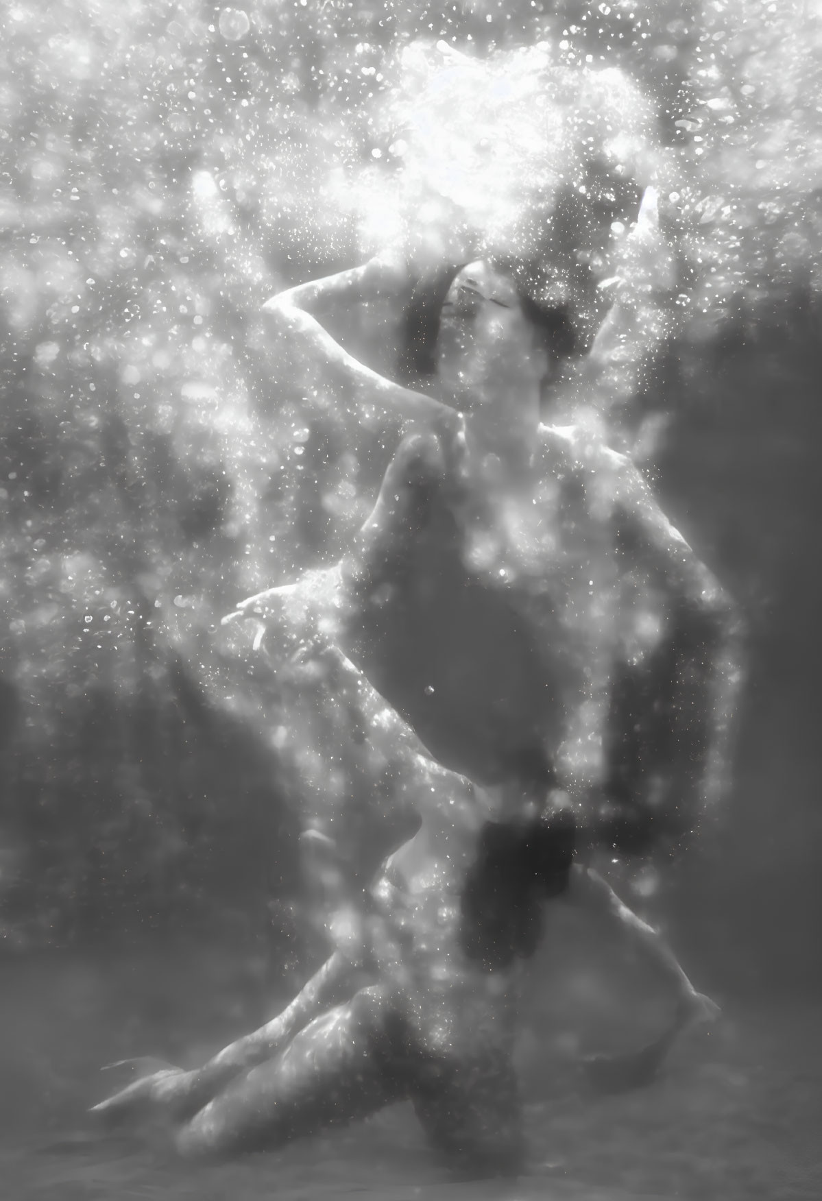 Elegant underwater portrait with bubbles and soft light.