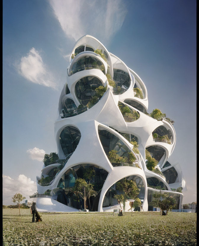 Organic bubble-like futuristic building with large glass windows in green surroundings.