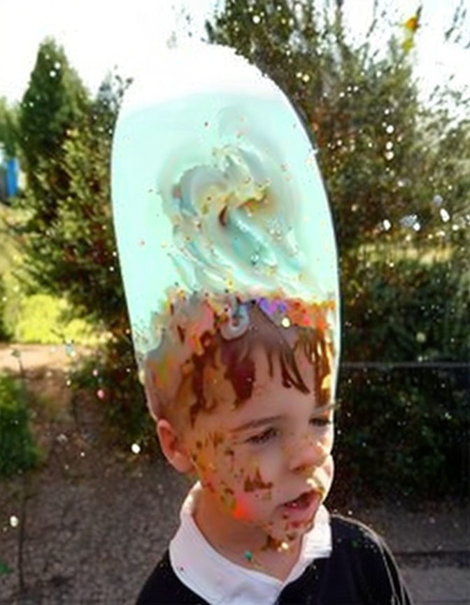 Child with surprised expression under bursting water balloon creates liquid hat effect.