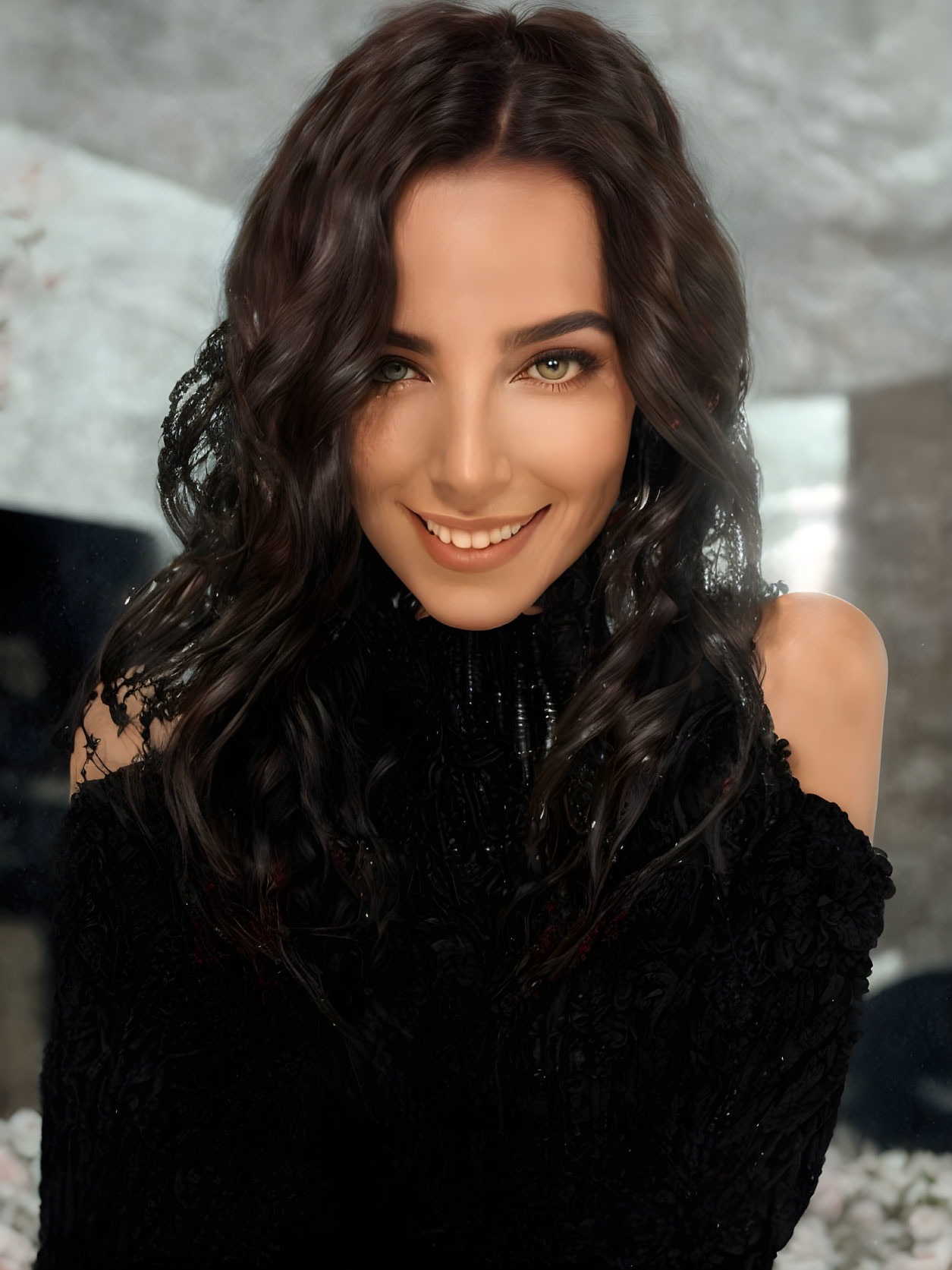 Portrait of woman with dark curly hair and green eyes in black outfit