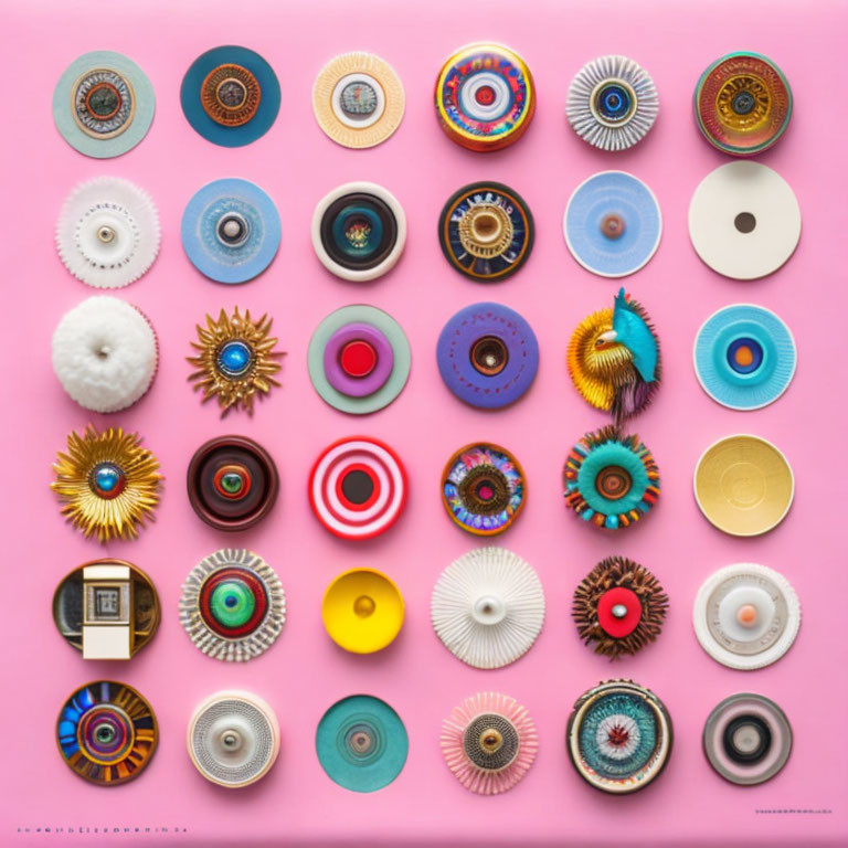 Vibrant circular objects in rows on pink background