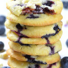 Pancakes with Whipped Cream, Berries, and Syrup on White Background