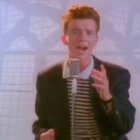 Vibrant painting of person with red hair singing in suit against pale backdrop