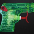 Translucent colorful toy gun with green, yellow, and red hues