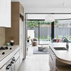 Modern Kitchen with Stainless Steel Appliances and White Sofa in Living Area