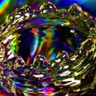 Close-up of vibrant, colorful eye with jewel-encrusted mask decorations