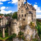 Medieval castle with central tower in lush greenery