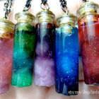 Ornate vials with cosmic scenes on colorful pearls