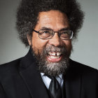 Portrait of a person with skull-like makeup, afro, mustache, and star-patterned suit