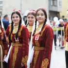 Pair in Red and Gold Costumes with Guitar at Cultural Event