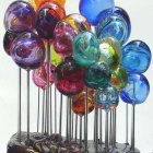 Colorful 3D abstract art with glossy metallic spheres and iridescent tubular structures