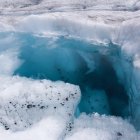 Majestic iceberg with blue ice formations in icy waters at sunset