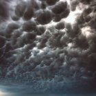 Powerful Lightning Strikes Over Dark Storm Clouds and Green Landscape