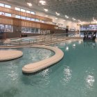 Curved Indoor Pool with Classical Columns and Large Windows