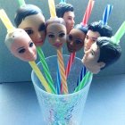 Colorful painted skull crowns on sticks in trash bin on blue background