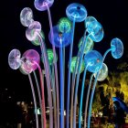 Vibrant glass jellyfish sculptures with glowing caps and long tendrils on aquatic-themed background