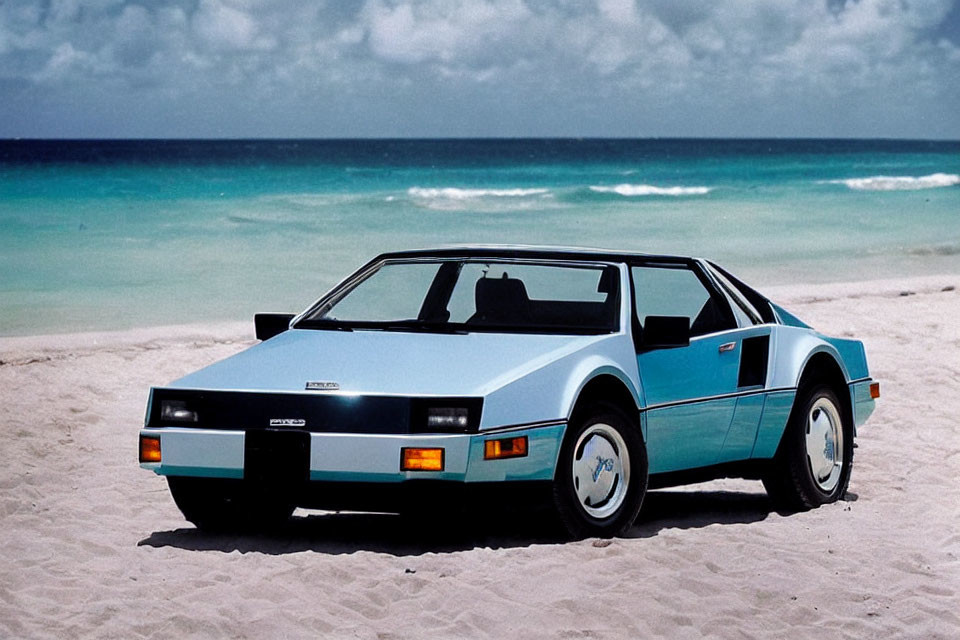 Vintage Blue and White Sports Car Parked on Sandy Beach