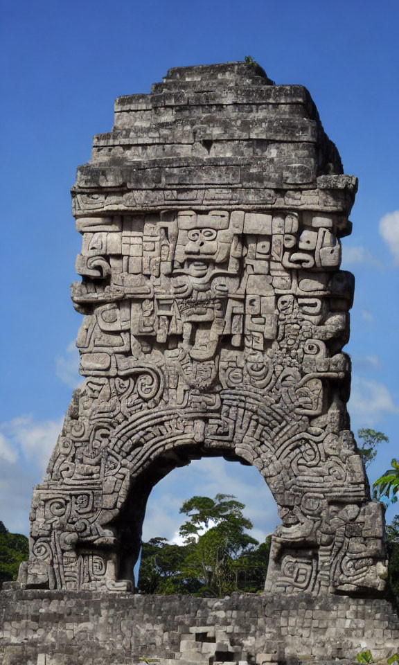 Ancient Mayan stone arch with intricate carvings and inscriptions