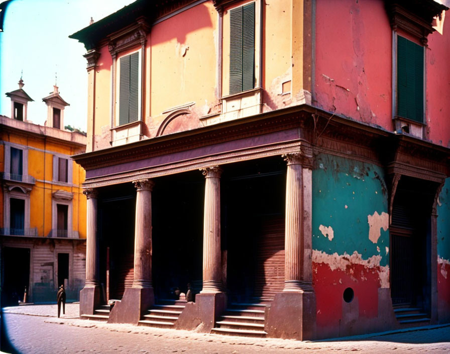 Colorful old buildings with peeling paint and classic architectural elements in a sunlit street