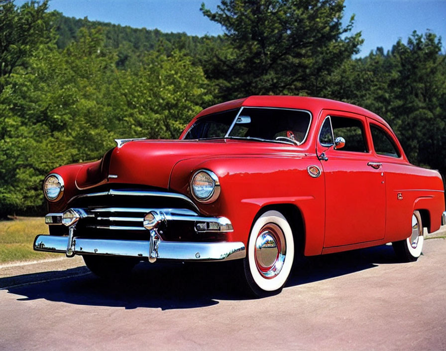 Vintage Red Car with Chrome Details Parked Among Green Trees