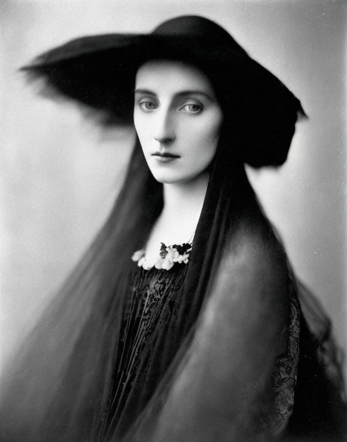 Vintage Black and White Portrait of Woman in Wide-Brimmed Hat and Floral Dress