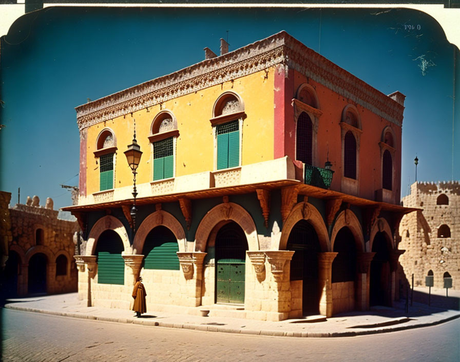 Vintage Photo of Person by Old Building with Arches and Green Shutters