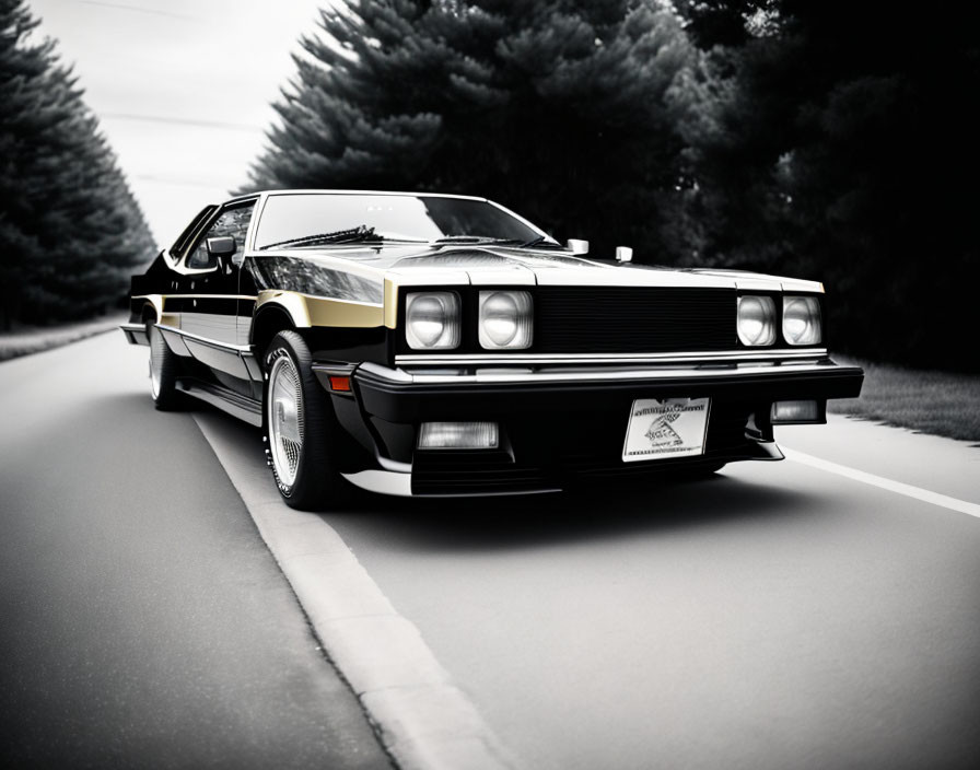 Vintage black sports car with pop-up headlights driving on tree-lined asphalt road in black and white.