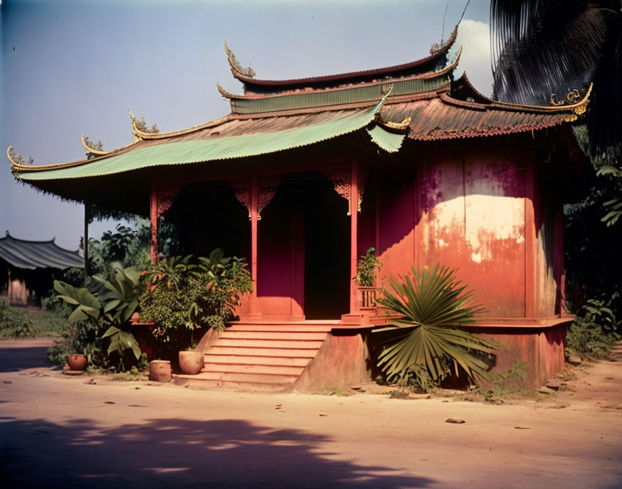 Traditional Asian Building with Red and Green Colors and Curved Roofing