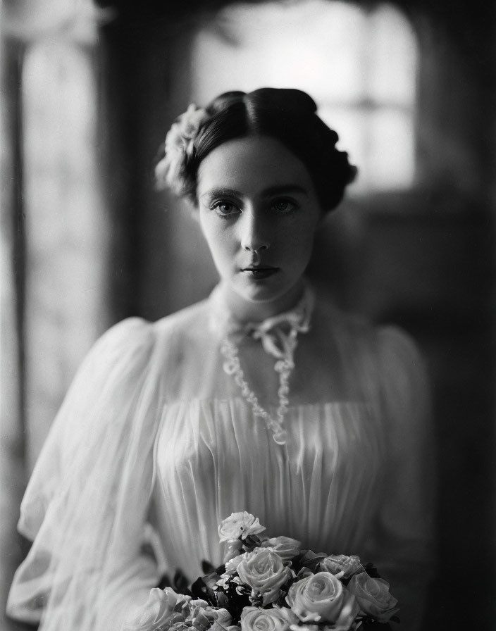 Monochrome portrait of woman in vintage dress with bouquet