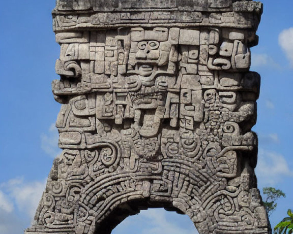 Ancient Mayan stone arch with intricate carvings and inscriptions