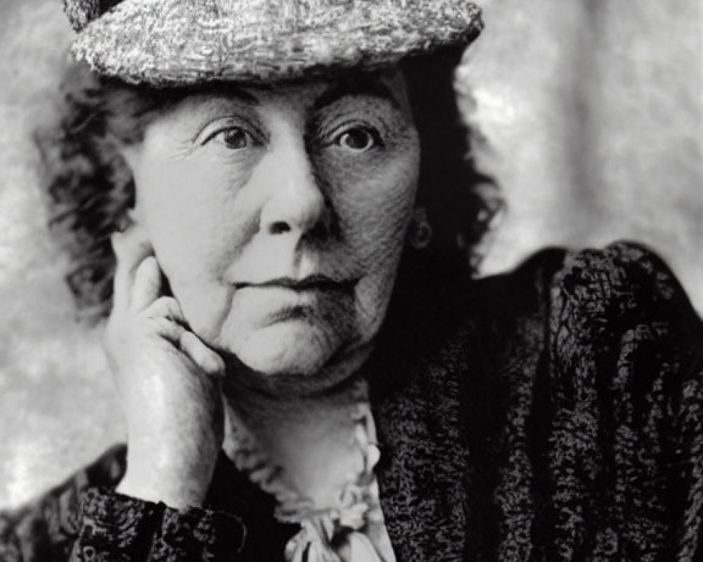 Elderly Woman in Layered Hat and Textured Dress Portrait