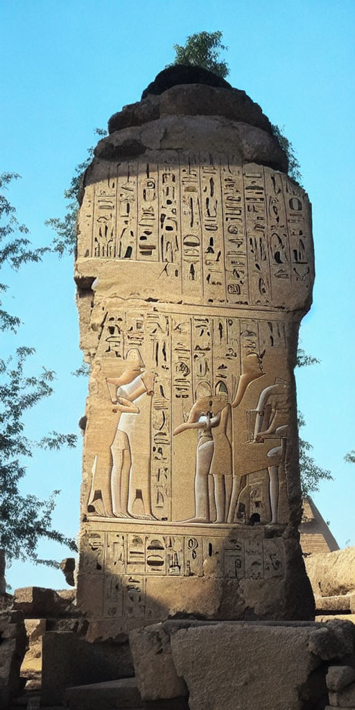 Ancient Egyptian hieroglyphics and carvings on weathered stone monument