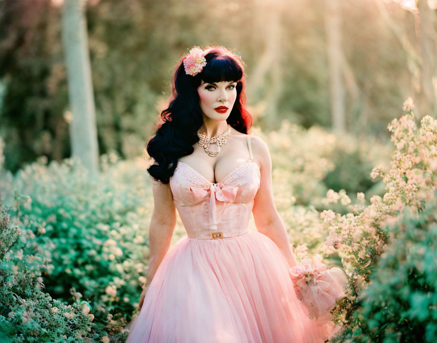 Woman in Vintage Pink Dress and Floral Headpiece Among Green Foliage