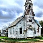 White Wooden Church with Steeple and Bell Tower Surrounded by Flowers