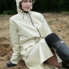 Person in White Hooded Robe with Dramatic Makeup on Gravel Path